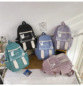 Five assorted colors of cute rabbit-ear canvas backpacks with multi-pocket design