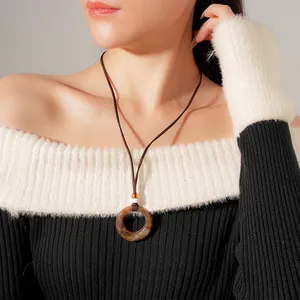 Vintage resin circular pendant necklace with brown amber texture on long cord
