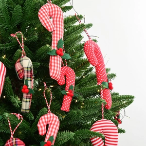 Christmas fabric candy cane hanging ornaments with holly berry on green pine tree