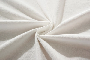 Macro shot of white washed cotton fabric texture with soft natural spiral folds
