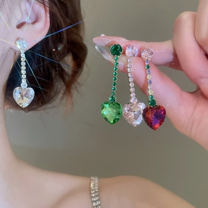 Detailed view of zircon heart tassel earrings in clear, green, and multicolor finishes