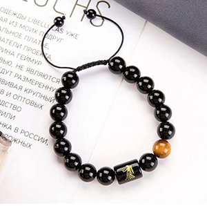 Detailed close-up of tiger eye stone and Virgo zodiac bead on adjustable beaded bracelet