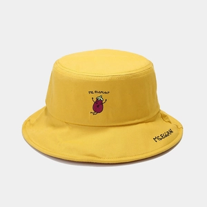 Close-up of yellow bucket hat featuring purple eggplant embroidery and MS. EGGPLANT text
