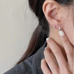 Minimalist 925 sterling silver water drop stud earrings worn by a model in natural light