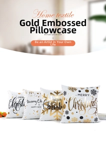 Close-up of four Christmas pillow covers with gold foil snowflakes and Merry Christmas text