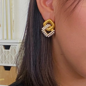 18K gold plated interlocking rhombus earrings with pearls and zircon on model