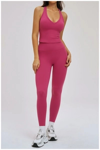 Close-up of rose red two-piece yoga set with V-neck sports bra and high-waisted leggings
