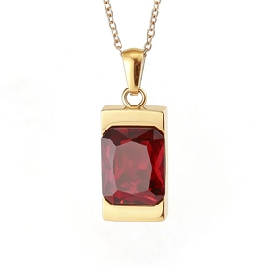 Detail of a large rectangular red gemstone pendant on a polished gold stainless steel chain