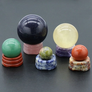 Natural crystal agate ball set with matching stone bases on a black background