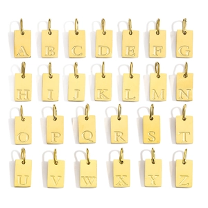 Macro view of 26 18K gold-plated stainless steel alphabet pendants in a grid layout