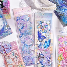 Detail of aesthetic diary stickers with ocean, butterfly, and floral motifs in soft tones