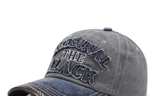 Detail of vintage washed baseball cap with 3D embroidery and leather-edged brim