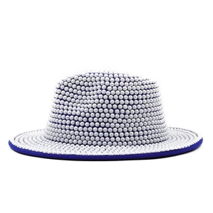 Detailed close-up of white pearls on the flat brim and royal blue edge of the wool hat