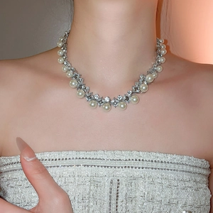 Close-up of elegant pearl and crystal diamond necklace on model for a vintage look