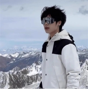 Silver reflective ski goggles and outdoor sports gear on snow mountain background
