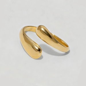 Minimalist gold teardrop bypass ring with polished finish in an adjustable open style