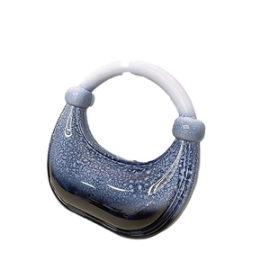 Artistic blue gradient acrylic crescent evening bag with bubble texture on white backdrop