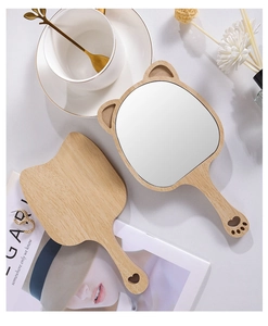 Detail of cat-shaped wooden hand mirrors with heart cut-out and paw print handle