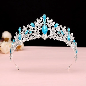 Close-up of silver bridal crown featuring sky blue marquise crystals and intricate filigree