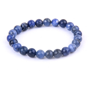 Natural lapis lazuli beaded bracelet with blue and white stone patterns on white background