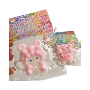 Soft pink rabbit and pig stress relief squishy toys in cute cartoon packaging