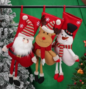 Hanging Christmas stockings with 3D Santa, Snowman and Reindeer on green background