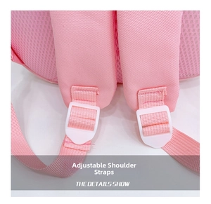 Detailed view of padded mesh shoulder straps with white adjustable buckles on pink backpack