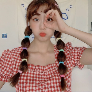 Colorful high-elasticity hair ties on a model with red plaid top and pigtails