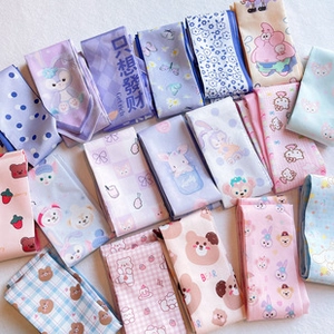 Detailed view of colorful fabric hair ribbons featuring cute cartoon characters and prints