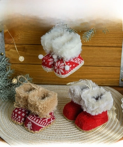 Detailed view of creative red fabric Christmas boot ornaments with knit patterns and fur trim