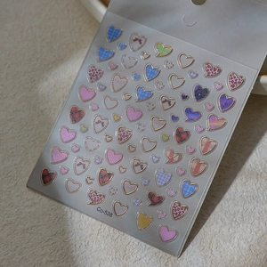 Detailed view of pink leopard and plaid heart nail stickers with gold metallic edges