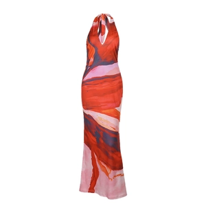 Detailed close-up of deep V-neck and abstract artistic print on halter maxi dress