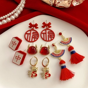 Festive red tassel earrings with Chinese characters and dragon pendants on silk