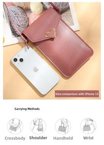 Detail view of pink crossbody phone bag with heart buckle beside an iPhone 13