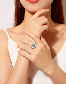 Macro detail of luxury S925 sterling silver ring with square emerald and diamond floral halo
