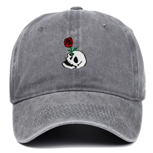 Close-up of skull and red rose embroidery on a vintage washed grey baseball cap