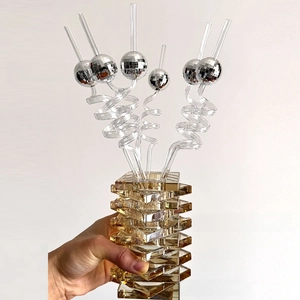 Close-up of six disco mirror ball straws set in a transparent vase for party decor