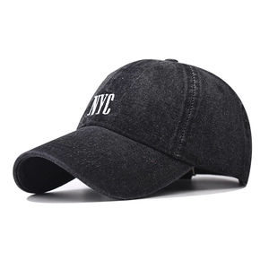 Black washed denim baseball cap with white NYC embroidery in a 45-degree side view