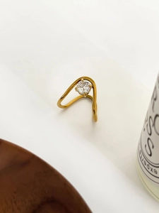 Detail of 18K gold titanium ring with round zircon stone in minimalist geometric design