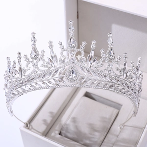 Detailed macro view of a luxury silver bridal crown with crystals in a white gift box