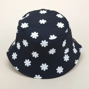Close-up of black cotton canvas bucket hat with white daisy print and neat stitching