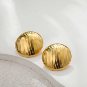 Detailed close-up of gold stainless steel earrings with vertical striped texture design