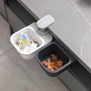 Rotating dual-bin kitchen waste collector mounted on cabinet door for easy waste disposal