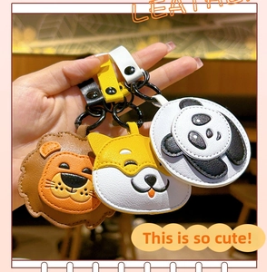 Detail showing lion dog and panda leather keychains with high quality stitching