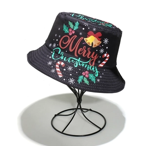 Detail of Christmas bucket hat with festive Merry Christmas patterns and golden bells
