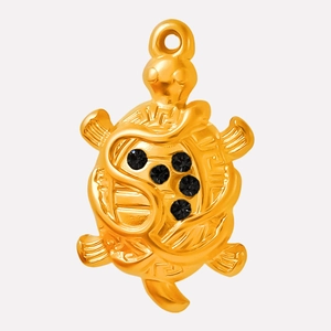Close-up of a 18k gold-plated turtle pendant with five black rhinestones and glossy finish