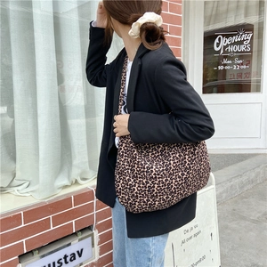 Street style view of leopard print canvas tote bag with large capacity for women
