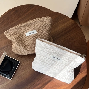 Close-up of jacquard cosmetic bags with textured weave and simple wish woven label