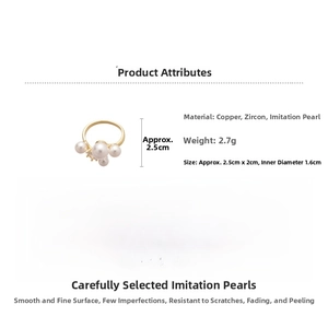 Detail view of gold C-shape ring featuring zircon inlays and white imitation pearls