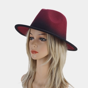 Close-up of red and black gradient wide brim fedora hat in soft felt material